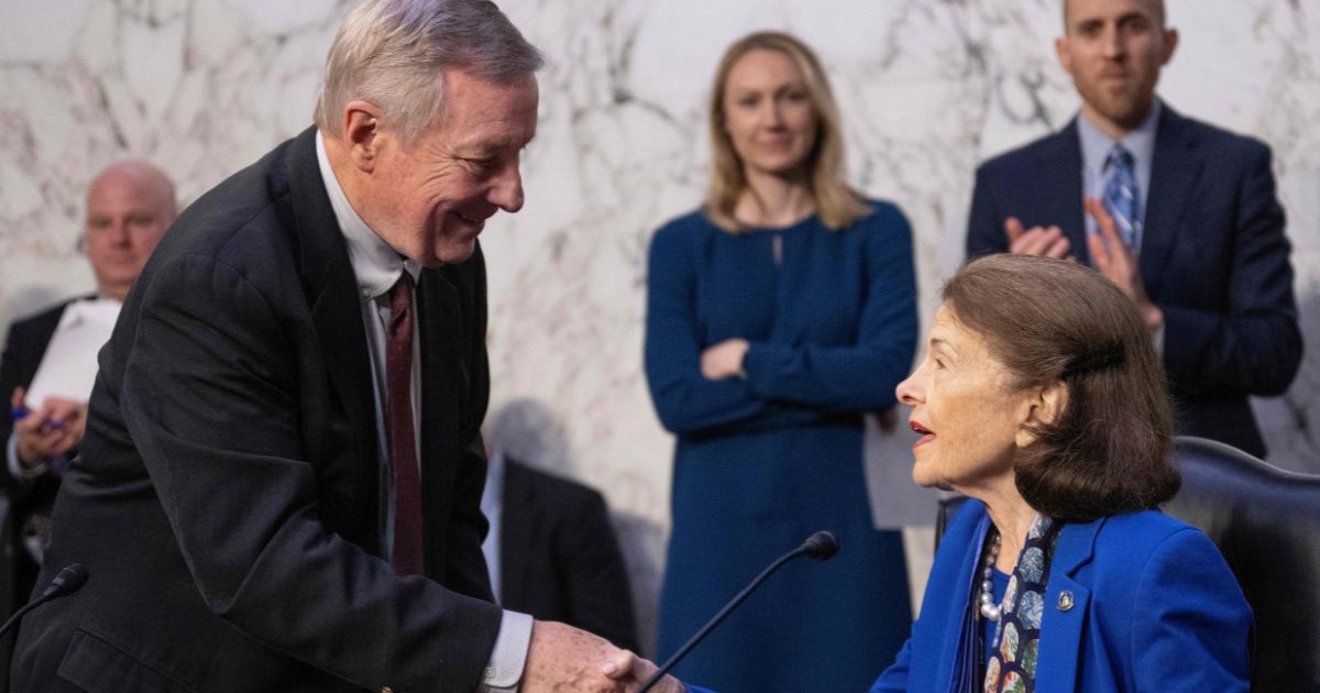 Sen. Dick Durbin of Illinois welcomes fellow Democrat Sen. Dianne Feinstein of California as she arrives for a Senate Judiciary Committee meeting on Capitol Hill in Washington on Thursday.