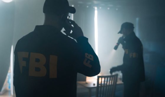 A scene from a movie depicts two FBI agents at the scene of a crime.