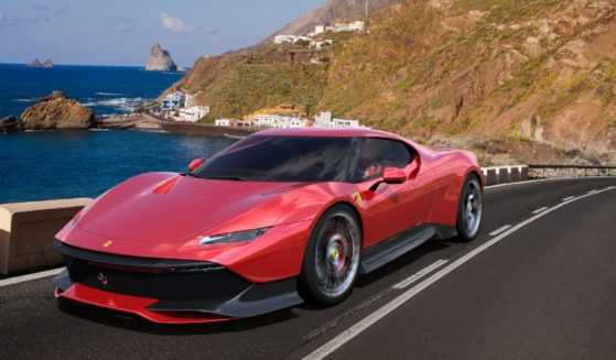 A Ferrari SP38 Deborah is driven along a winding road over the ocean on Tenerife, the largest of Spain's Canary Islands, in May 2020.