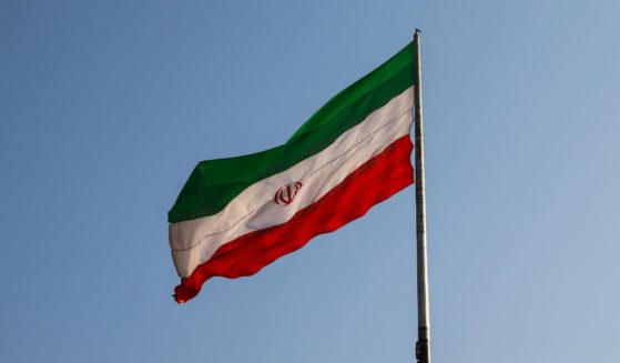 The Iranian flag flies in the above stock image.