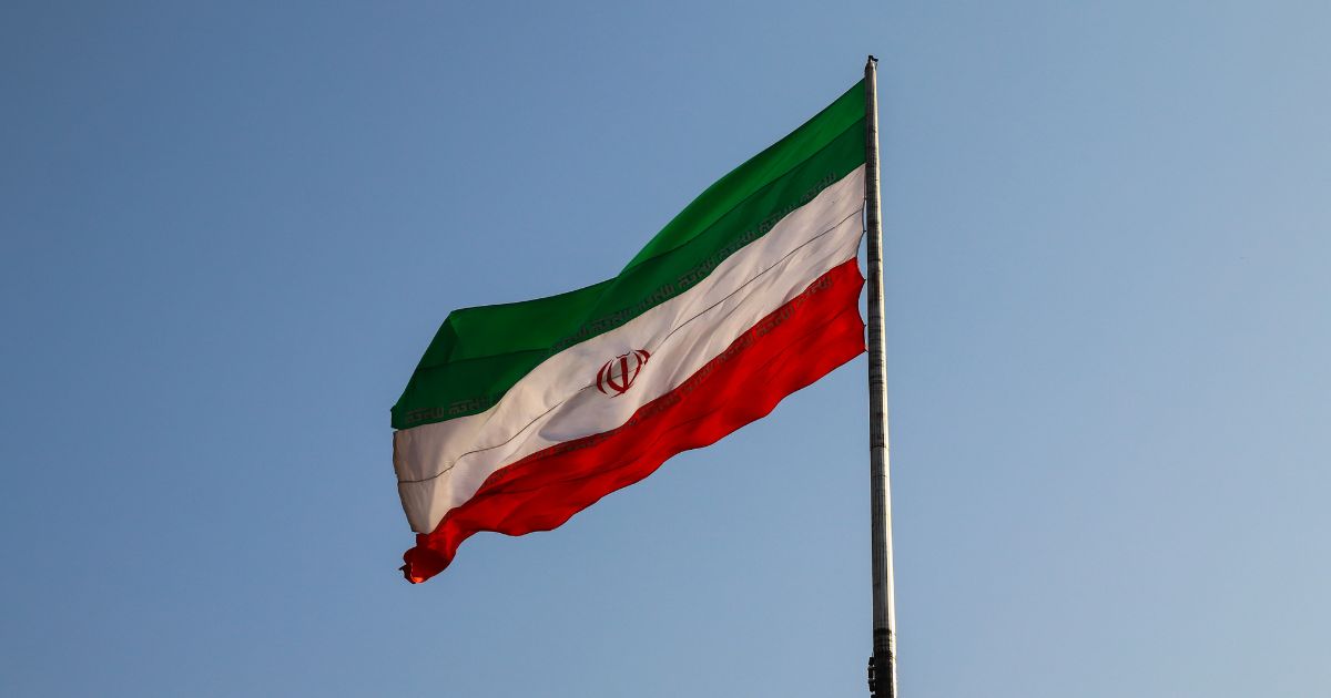The Iranian flag flies in the above stock image.