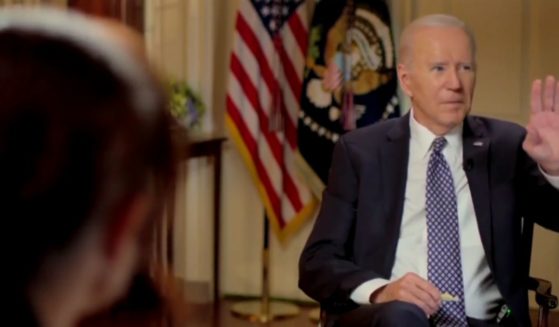 President Joe Biden gestures to a staffer who was trying to interrupt during an interview broadcast Friday with MSNBC's Stephanie Ruhle.