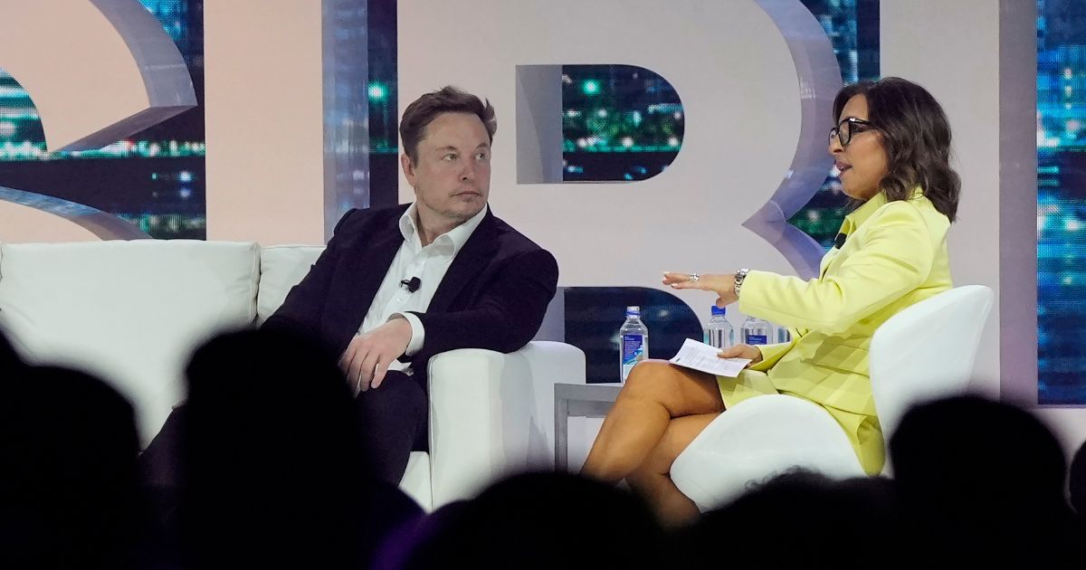 Twitter CEO Elon Musk, center, speaks with Linda Yaccarino, chairman of global advertising and partnerships for NBC, at the POSSIBLE marketing conference, Tuesday, April 18, 2023, in Miami Beach, Florida. Musk said that he has found a new CEO for Twitter, or X Corp. as it’s now called, and multiple media reports identify her as Yaccarino, (Rebecca Blackwell / Associated Press)