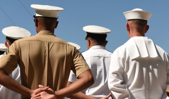 Sailors stand at attention in the above stock image.