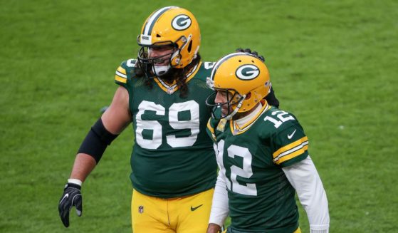 David Bakhtiari, left, and Aaron Rodgers celebrate after the Green Bay Packers scored a touchdown against the Jacksonville Jaguars during a game at Lambeau Field on Nov. 15, 2020.