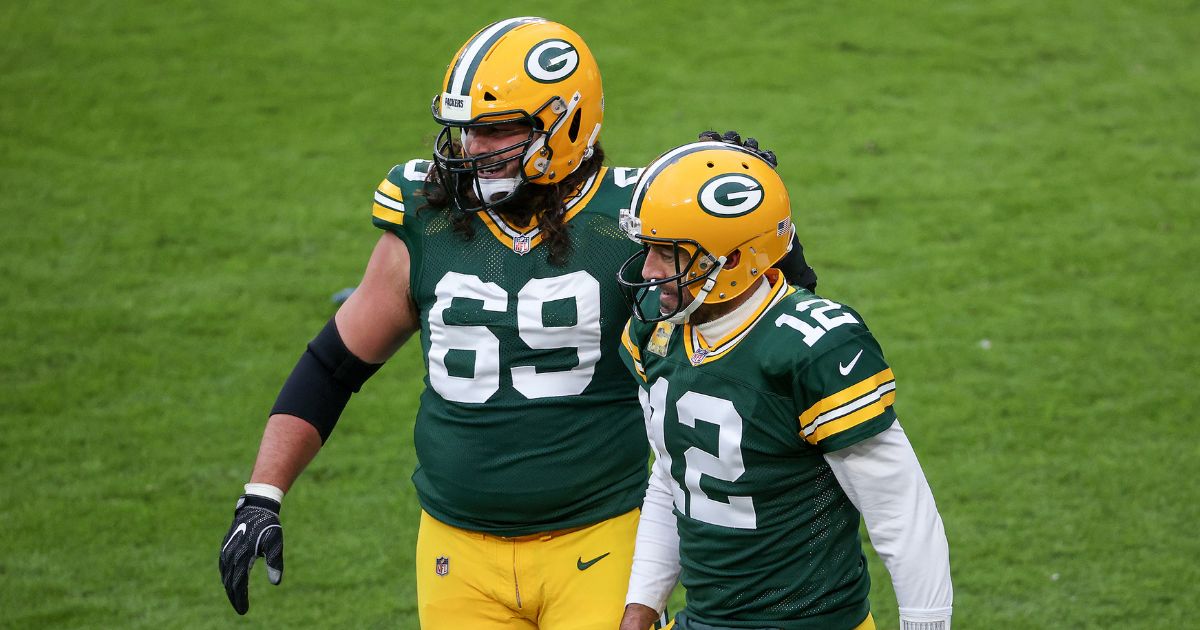David Bakhtiari, left, and Aaron Rodgers celebrate after the Green Bay Packers scored a touchdown against the Jacksonville Jaguars during a game at Lambeau Field on Nov. 15, 2020.
