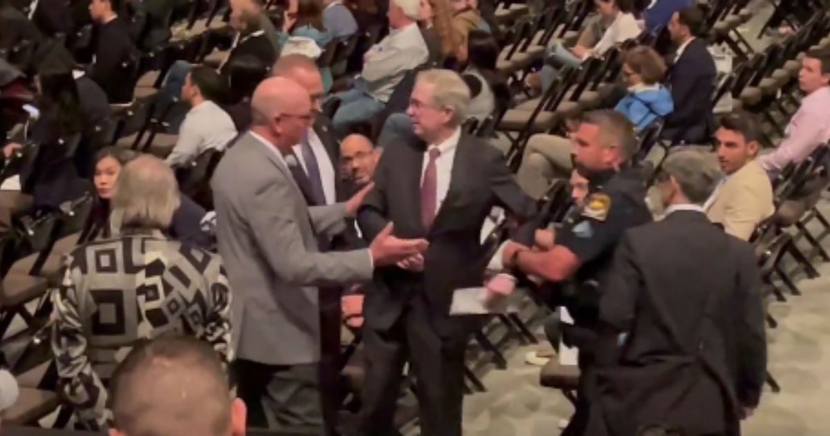 Video shows him being forcefully taken away after speaking about the "wrong" topic.