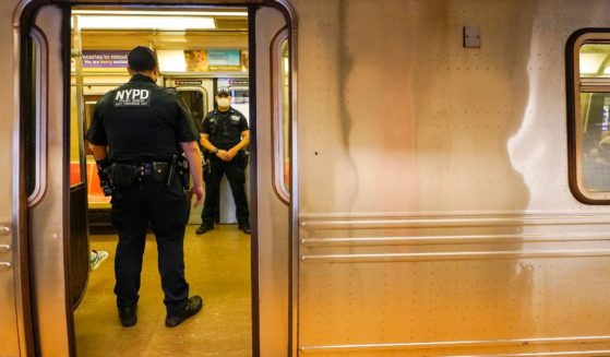 New York Police Officers with the Transit Bureau Anti Terrorism Unit board a train at the Canal St. Q station, Tuesday, May 24, 2022, in New York. (Mary Altaffer / Associated Press)