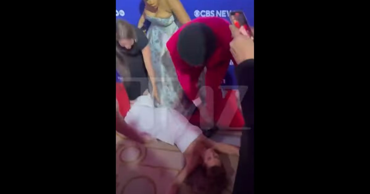MSNBC anchor Stephanie Ruhle lies on the ground after falling.