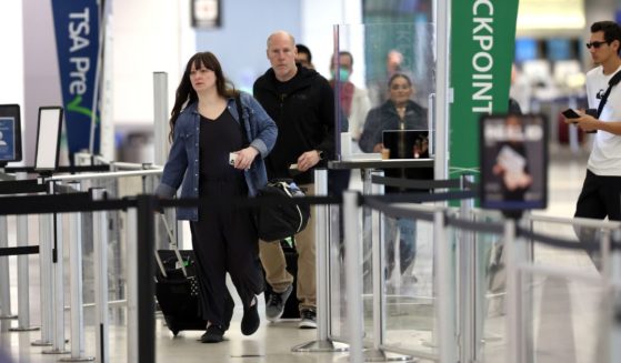 Airline passengers prepare to enter a security checkpoint at San Francisco International Airport on April 19, 2022.