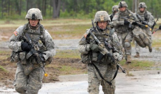 Soldiers assigned to Company C, 2nd Battalion, 69th Armor Regiment, 3rd Heavy Brigade Combat Team, 3rd Infantry Division run from a UH-60 Blackhawk and seek cover during a mock air assault at the Selby Military Operations on Urbanized Terrain training site at Fort Benning, Georgia, on May 5, 2009.