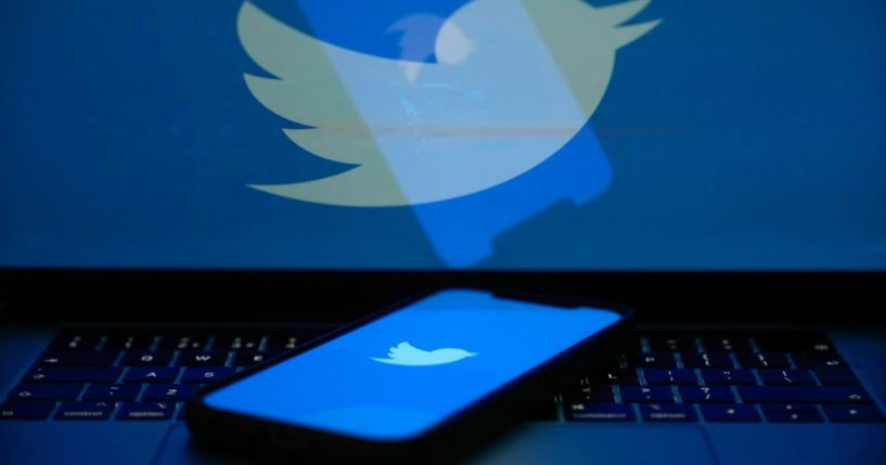 The Twitter logo is seen on a computer screen and cellphone on April 21 in Knutsford, England.
