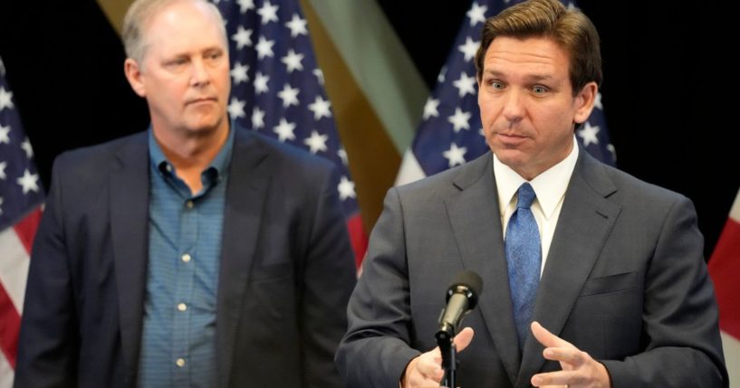 Florida Gov. Ron DeSantis speaks at a news conference on April 17 as Wilton Simpson, the state's commissioner of agriculture, listens at the Reedy Creek Administration Building in Lake Buena Vista, the site of Disney World.
