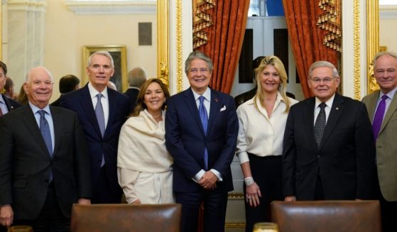 New Jersey Democratic Sen. Bob Menendez, second from right, poses for a photo with members of the Senate Foreign Relations Committee on Capitol Hill on Dec. 20.