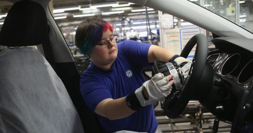 An employee installs an airbag into the steering wheel of an automobile at the Volkswagen factory in Wolfsburg, Germany, in this file photo from March 2017. The National Highway Traffic Safety Administration is pressuring air bag manufacturer ARC Automotive to recall airbag inflators over an alleged defect. The devices have been installed in dozens of types of vehicles including Volkswagen, Ford, BMW and GM vehicles. ARC Automotive said any problems are related to isolated auto manufacturing issues.