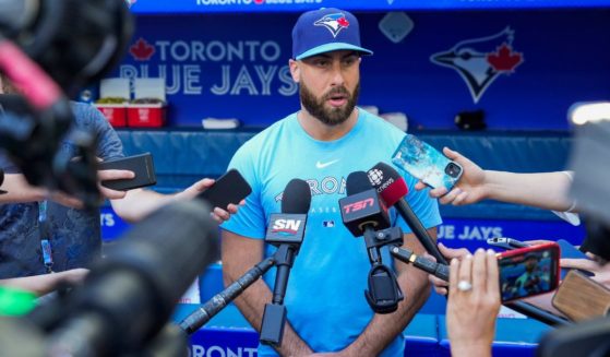 Anthony Bass #52 of the Toronto Blue Jays makes a statement to the media before playing the Milwaukee Brewers in their MLB game at the Rogers Centre on Tuesday in Toronto, Ontario, Canada.