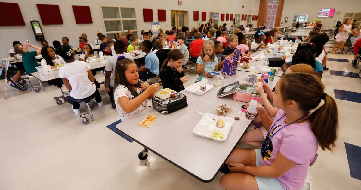 Students at Madison Crossing Elementary School in Canton, Miss., eat lunch in the school's cafeteria on Friday, Aug. 9, 2019. (Rogelio V. Solis / Associated Press)