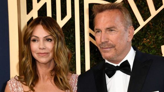 Actor Kevin Costner, right, and Christine Baumgartner, left, arrive for the 28th Annual Screen Actors Guild Awards at the Barker Hangar in Santa Monica, California, on Feb. 27, 2022.