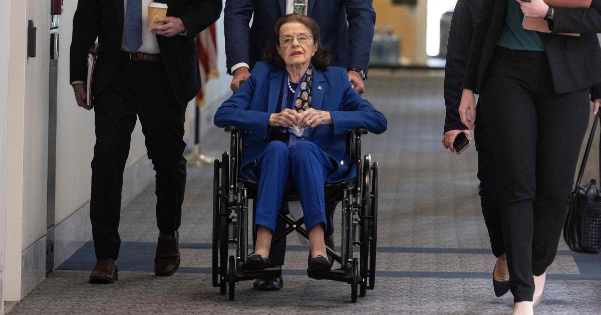 Senator Dianne Feinstein (D-CA) is pushed in a wheelchair as she arrives for a Senate Judiciary Committee meeting on Capitol Hill in Washington, D.C., on Thursday.