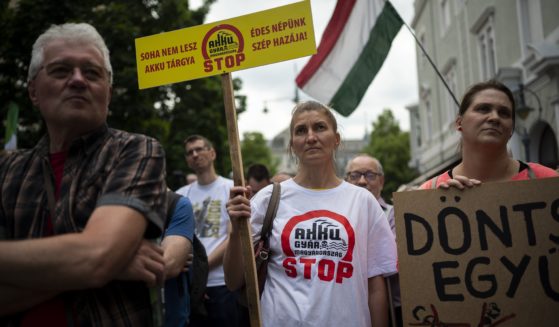 Residents gather in Debrecen, Hungary, during a demonstration against a factory that will produce batteries for electric vehicles built by a China-based company on Tuesday, May 23, 2023. (Denes Erdos / Associated Press)