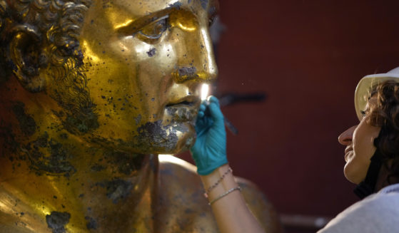 Vatican Museum restorer Alice Baltera works on the bronze Hercules statue in the Round Hall of the Vatican Museums on Thursday.