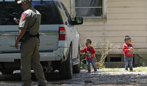 On Sunday, Josue, left, and Nathan Barcenas, right, play outside their home as law enforcement continues to investigate the neighborhood where a mass shooting occurred Friday night, in Cleveland, Texas.