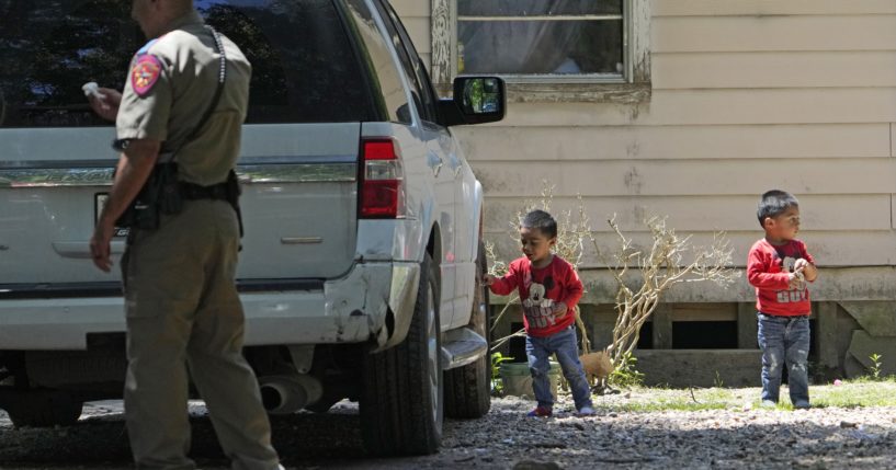 On Sunday, Josue, left, and Nathan Barcenas, right, play outside their home as law enforcement continues to investigate the neighborhood where a mass shooting occurred Friday night, in Cleveland, Texas.