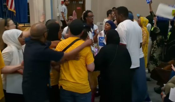 During the Minneapolis DFL Ward 10 meeting scheduled to chose a city council nominee, Council Member Aisha Chughtai and her supporters took the stage for her speech, then Nasri Warsame supporters advanced towards the stage, and began pushing and shoving.