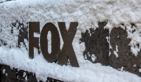 The FOX network sign is covered in snow outside at News Corporation's building on December 17, 2020 in New York City.