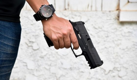 A man holds a gun in this stock image.