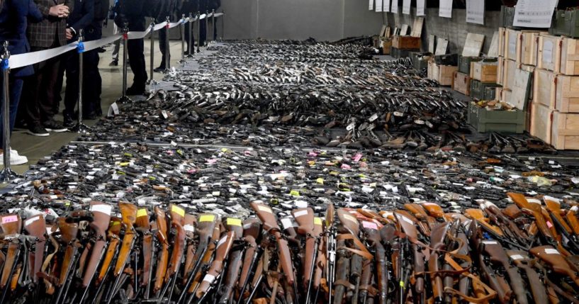 In this photo provided by the Serbian Presidential Press Service, Serbian President Aleksandar Vucic, left, inspects weapons collected as part of an amnesty near the city of Smederevo, Serbia, on Sunday.