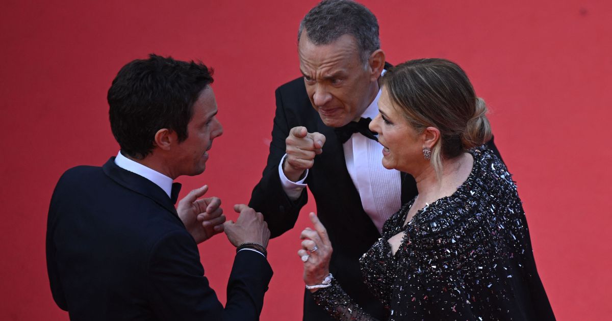 Actor Tom Hanks, center, and actress Rita Wilson speak with a staff member as they arrive for the screening of the film "Asteroid City" during the 76th edition of the Cannes Film Festival in Cannes, southern France, on Tuesday.