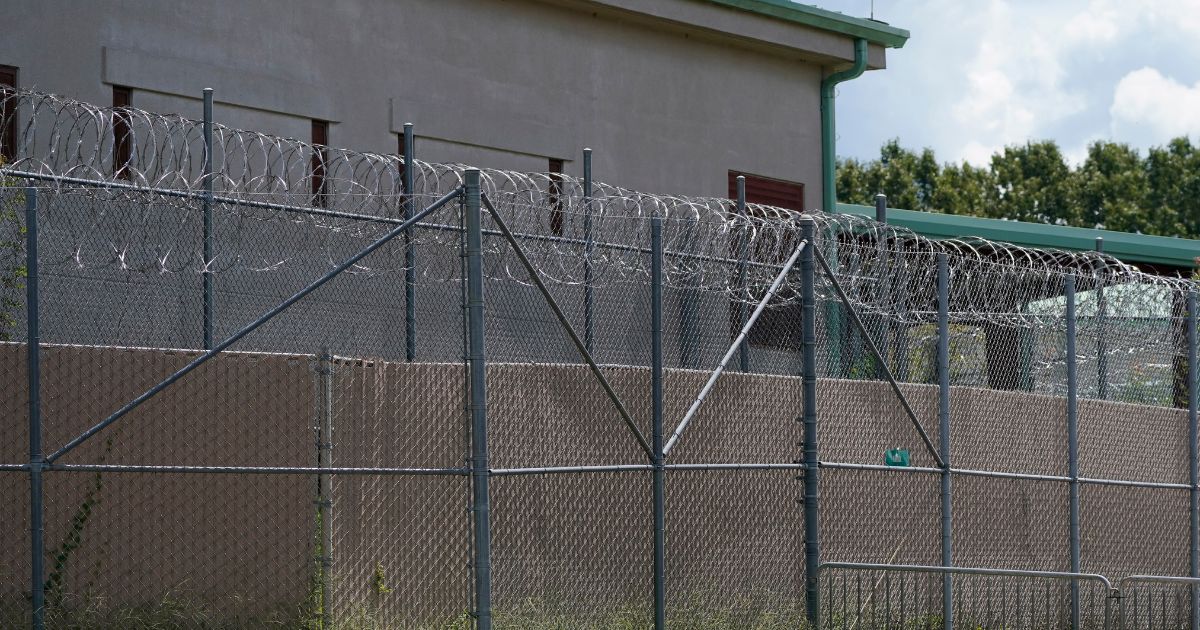 Rolls of razor wire line the top of the security fencing at the Raymond Detention Center in Raymond, Miss., Aug. 1, 2022. (Rogelio V. Solis / Associated Press)