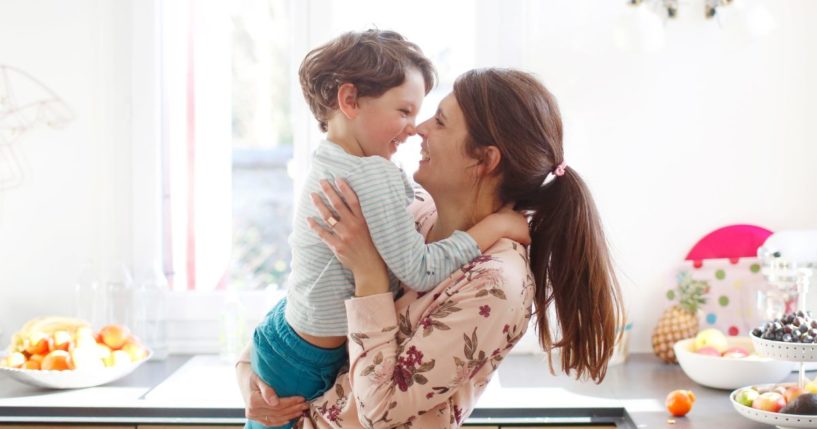 A mother holds her son in the above stock image.