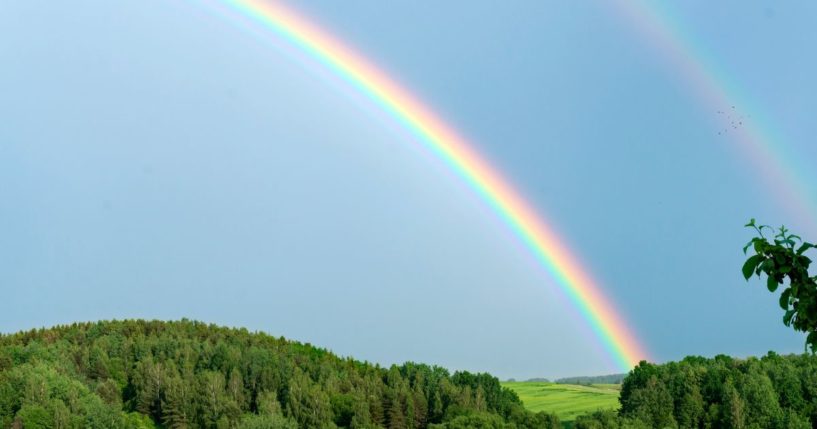 A rainbow is seen in the above stock image.