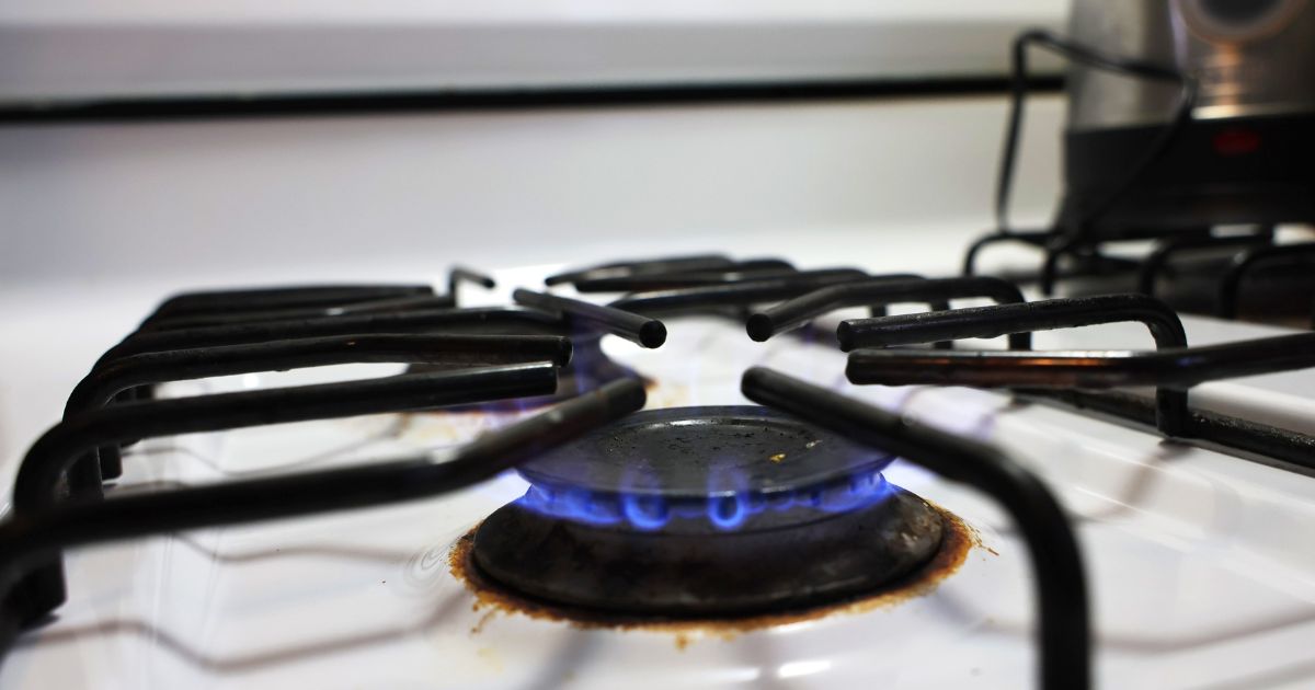 In this photo illustration, a flame burns on a gas stove on April 28 in New York City.