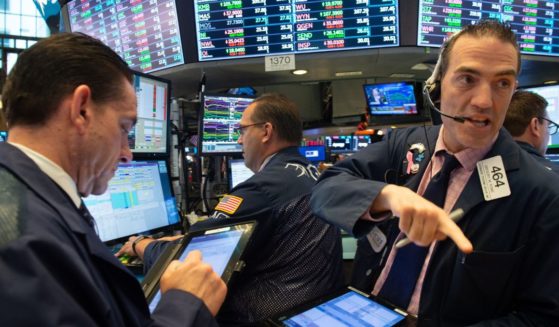 Traders work on the floor of the Dow Industrial Average at the New York Stock Exchange on May 29, 2018, in New York.
