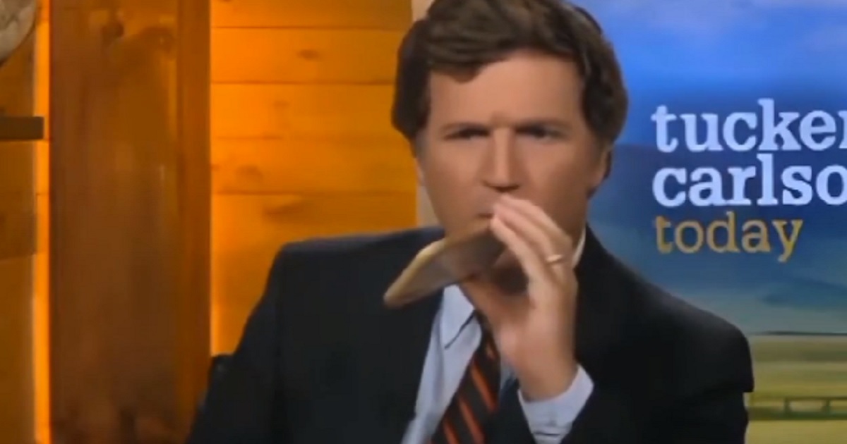 Tucker Carlson is pictued talking on a cell phone on the set of "Tucker Carlson Today."