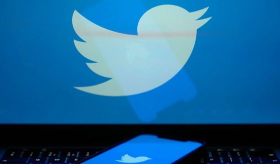 In this photo illustration the Twitter logo is seen on a computer screen and mobile cellphone on April 21, 2023 in Knutsford, United Kingdom.
