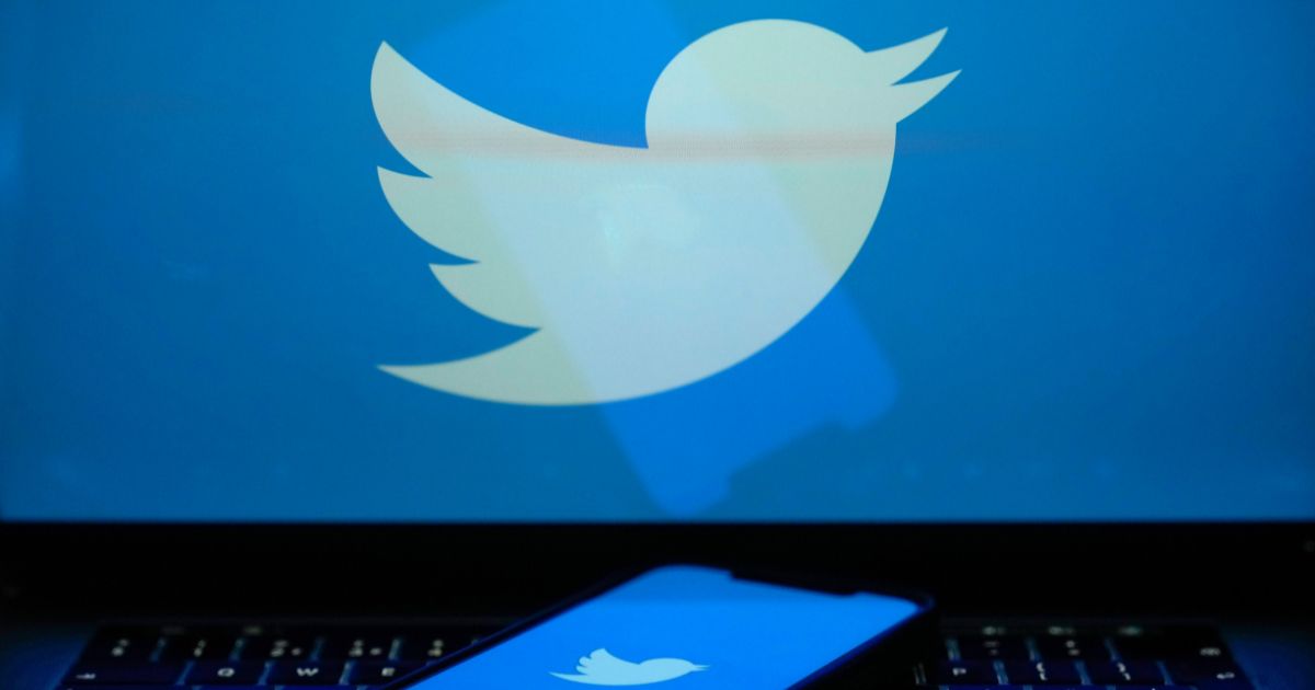 In this photo illustration the Twitter logo is seen on a computer screen and mobile cellphone on April 21, 2023 in Knutsford, United Kingdom.