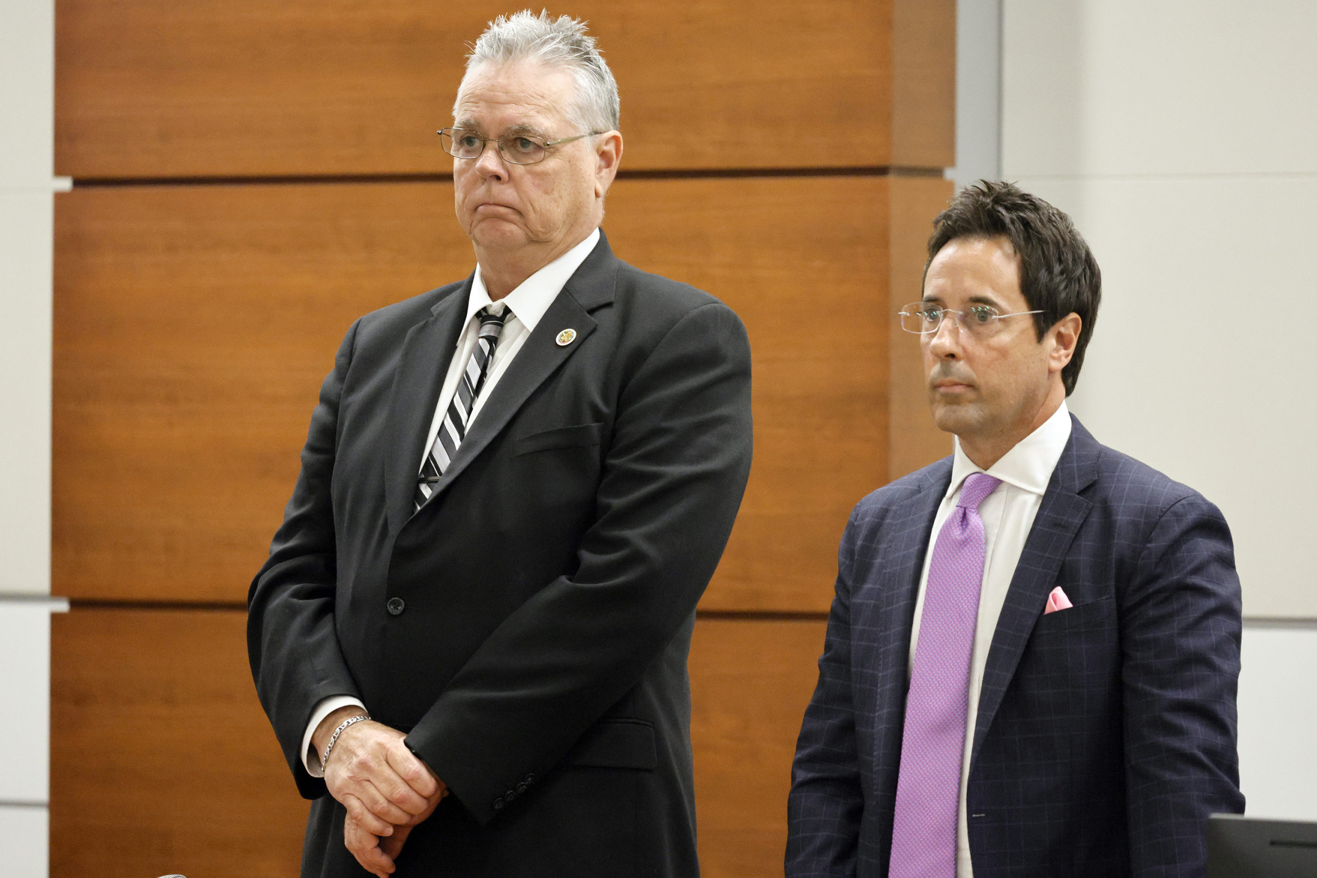 Former Marjory Stoneman Douglas High School School Resource Officer Scot Peterson, left, and defense attorney Mark Eiglarsh, right, stand as the jury enters the courtroom to be dismissed on Wednesday from Broward County Courthouse in Fort Lauderdale, Florida.