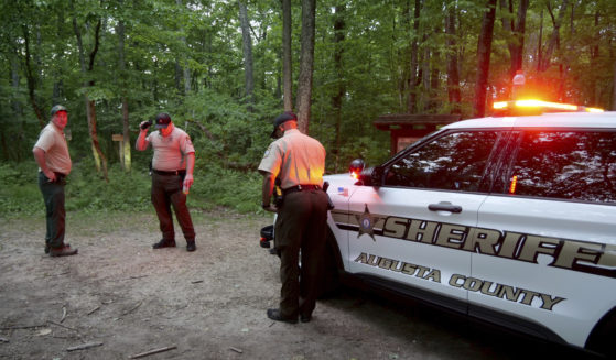 Authorities secure the entrance to Mine Bank Trail, an access point to the rescue operation along the Blue Ridge Parkway where a Cessna Citation crashed over mountainous terrain near Montebello, Virginia, Sunday.