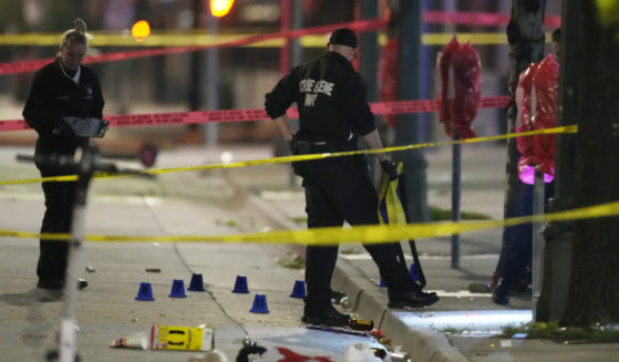 Denver Police Department investigators work the scene of a mass shooting along Market Street between 20th and 21st avenues during a celebration after the Denver Nuggets won the team's first NBA Championship early Tuesday.