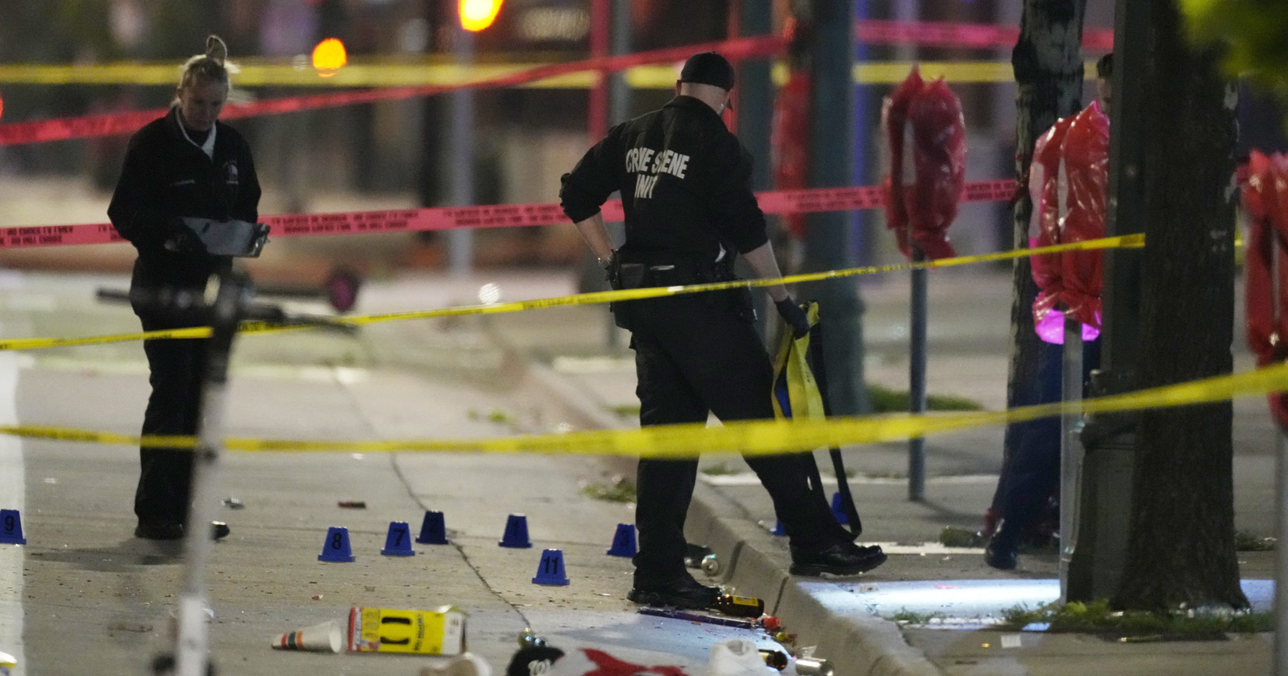 Denver Police Department investigators work the scene of a mass shooting along Market Street between 20th and 21st avenues during a celebration after the Denver Nuggets won the team's first NBA Championship early Tuesday.