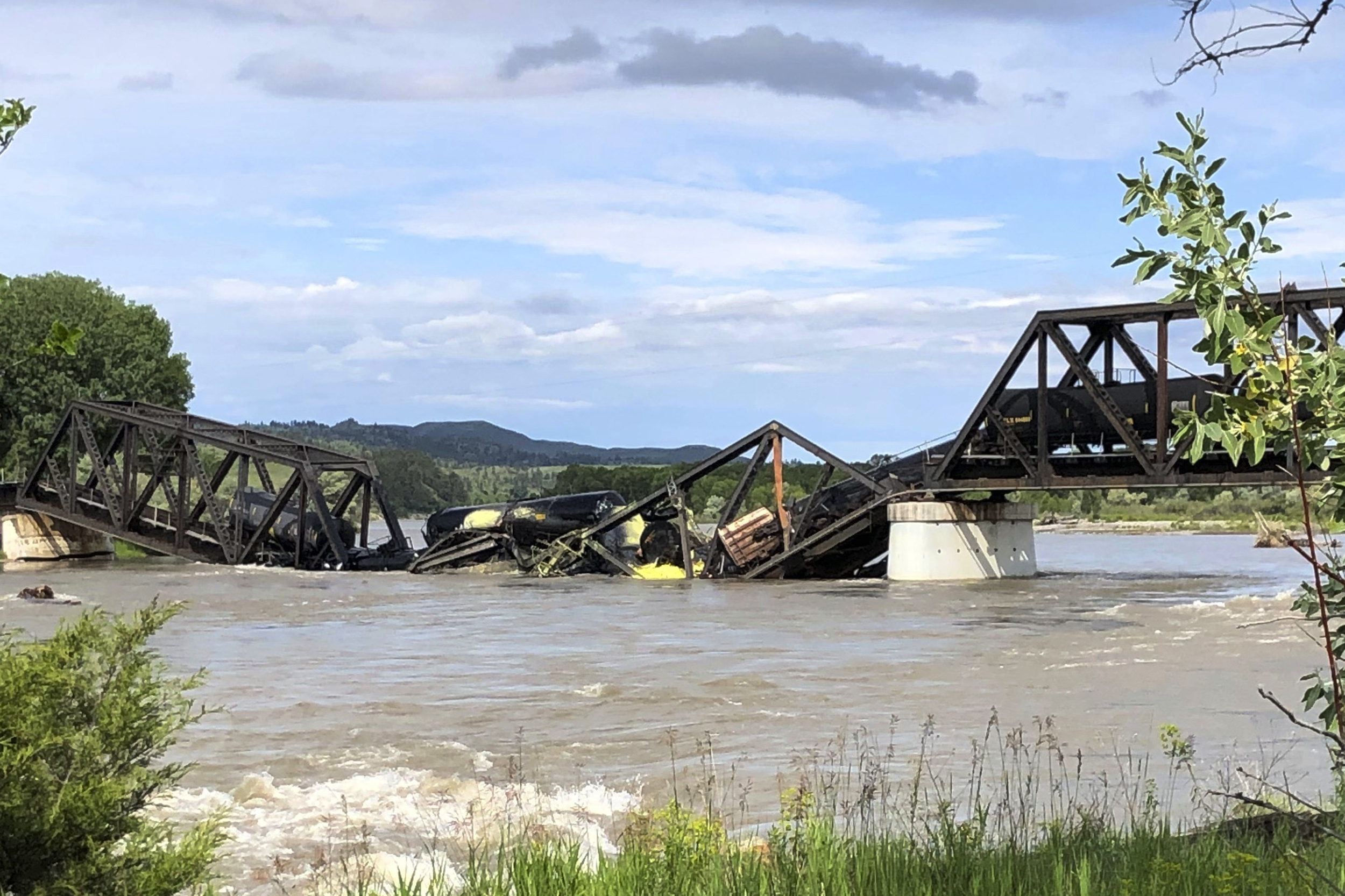 Several train cars are immersed in the Yellowstone River after a bridge collapse near Columbus, Montana, on Saturday.