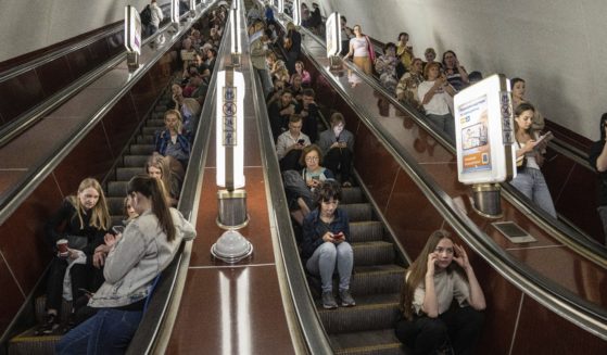 People take cover at a metro station during a Russian rocket attack in Kyiv, Ukraine, Monday.