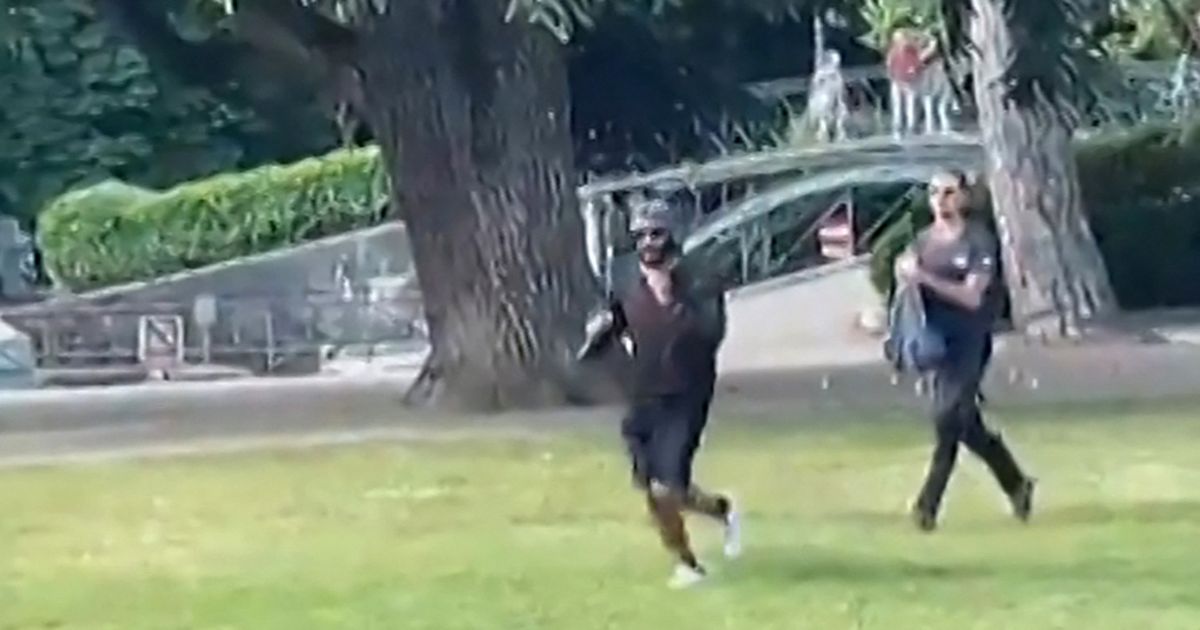 A screen grab taken from a video obtained by AFPTV shows a man armed with a knife running away after he attacked a group of preschool children playing by a lake in the French Alps city of Annecy on Thursday. The suspect is a Syrian in his early 30s who was granted refugee status in Sweden in April, a police source told AFP.