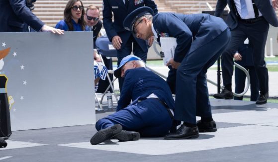 President Joe Biden is helped up after falling during the graduation ceremony at the U.S. Air Force Academy, just north of Colorado Springs in El Paso County, Colorado, on Thursday.