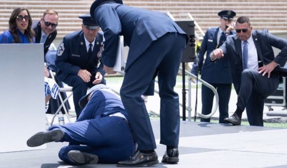 President Joe Biden falls during the graduation ceremony at the U.S. Air Force Academy near Colorado Springs, Colorado, on Thursday.