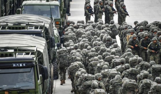 Troops assigned to a brigade under the Chinese People's Liberation Army 73rd Group muster in emergency to set out for the designated real-combat training field on Nov. 21, 2022.